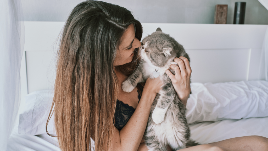 a person cuddling with a pet.